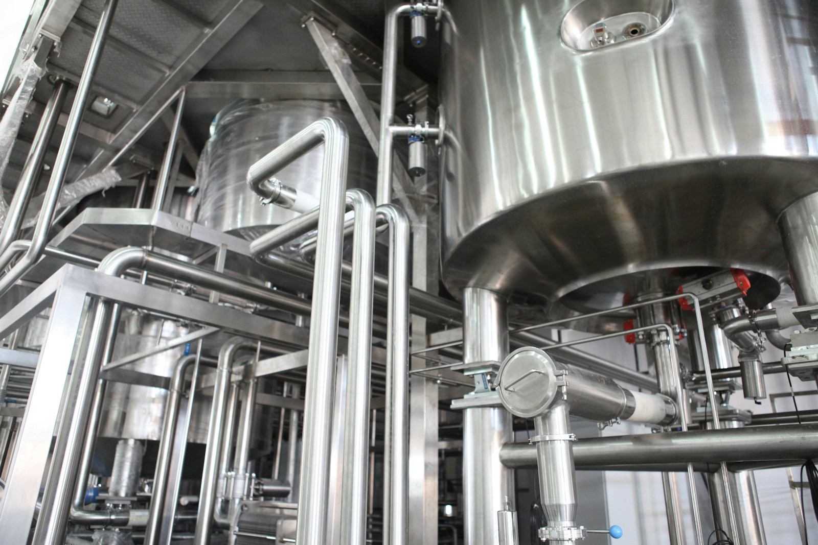 Stainless steel mixing tanks and pipework in a production facility